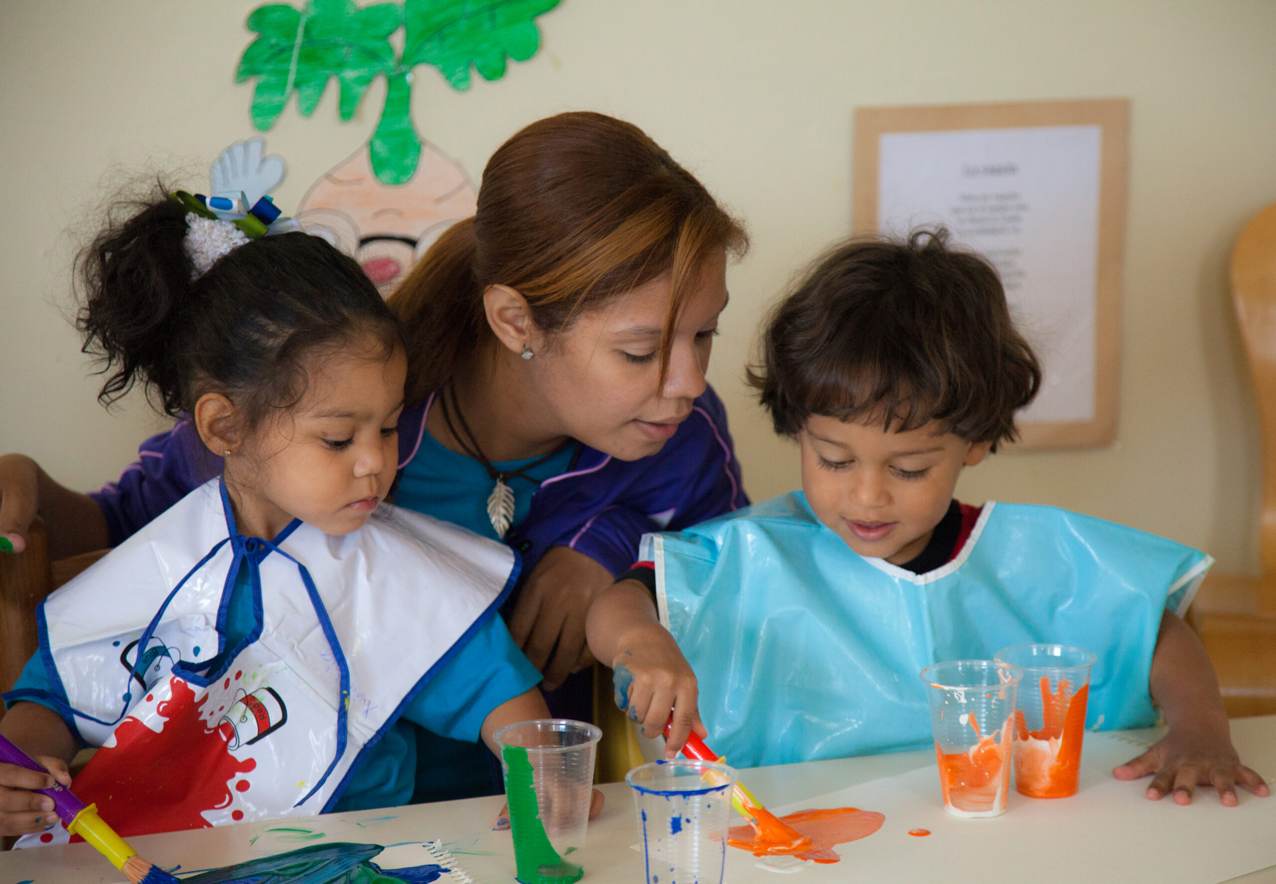 Teacher painting with children