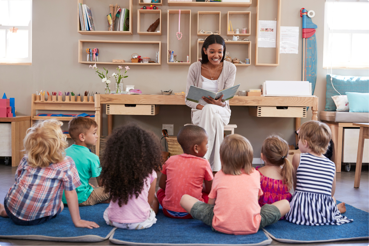 The educator reads to students during circle time