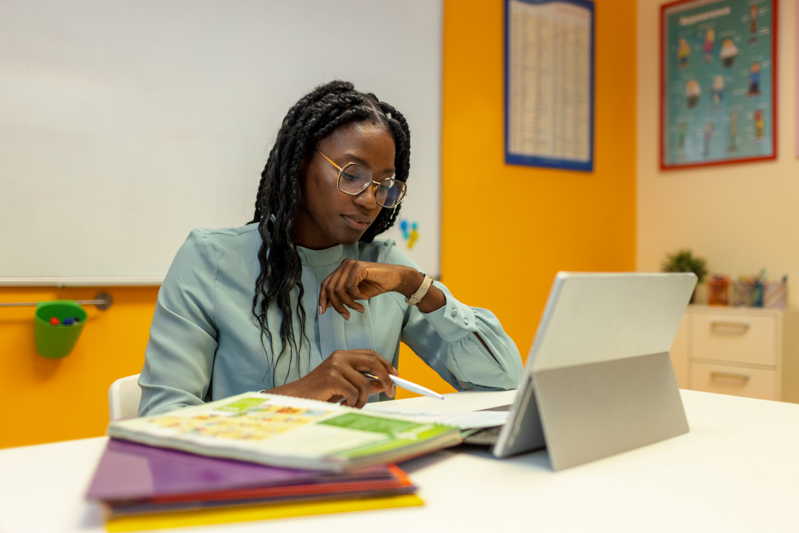 Teacher studying in front of laptop computer